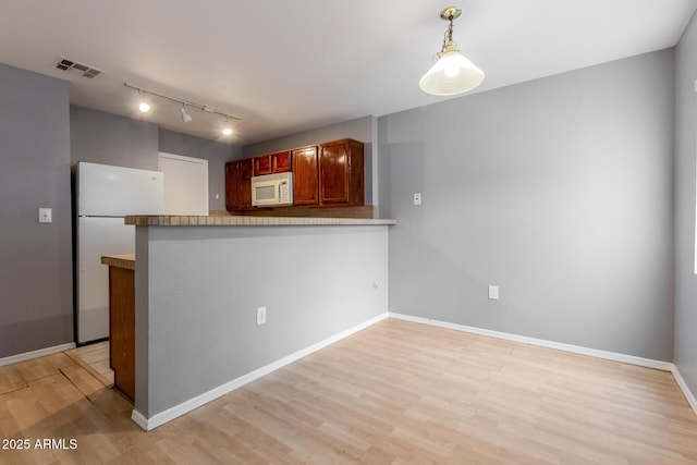 125 S 56th St Unit 124, Mesa, AZ 85206 - kitchen featuring white appliances, track lighting, light wood finished floors, a peninsula, and baseboards