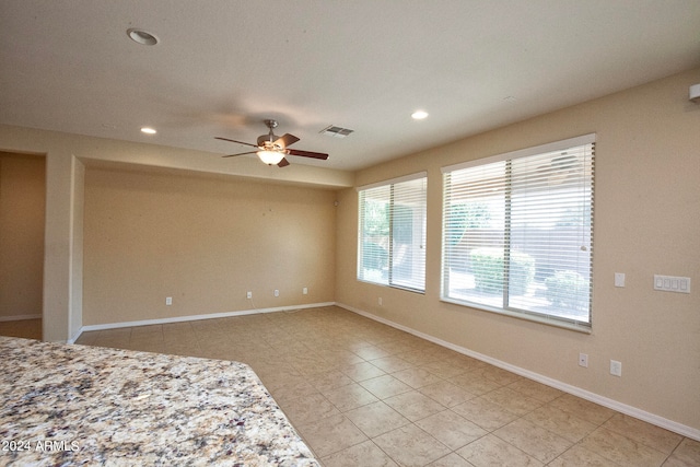 interior space with ceiling fan