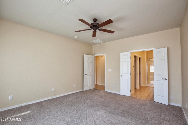 unfurnished bedroom with ceiling fan and light carpet