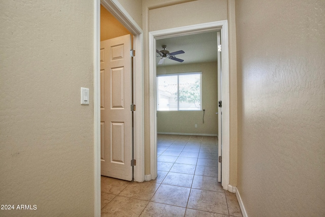 hall featuring light tile floors