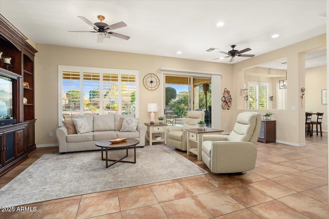 tiled living room with ceiling fan