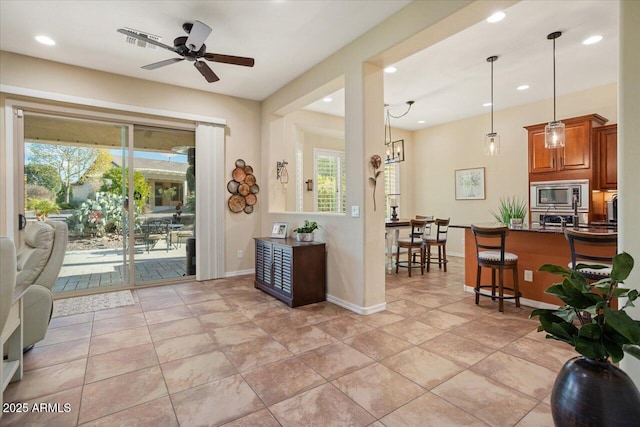 entrance foyer featuring light tile patterned flooring, plenty of natural light, and ceiling fan