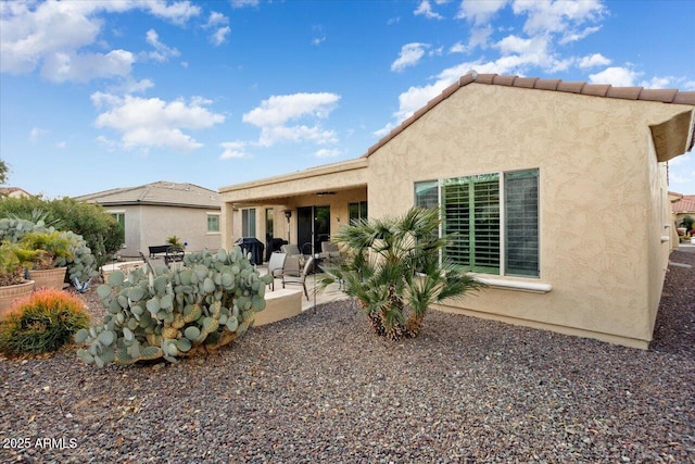 rear view of house with a patio