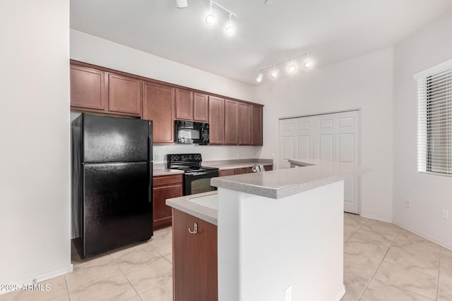 kitchen with light tile patterned floors, a center island with sink, and black appliances