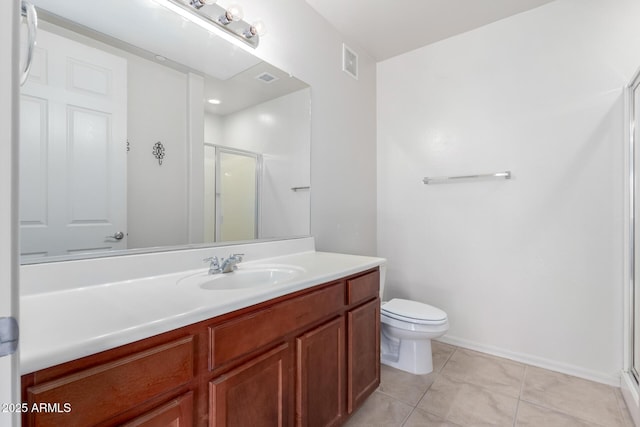 bathroom with tile patterned flooring, vanity, toilet, and an enclosed shower