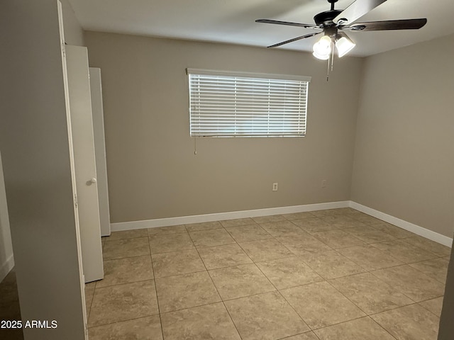 tiled spare room featuring ceiling fan