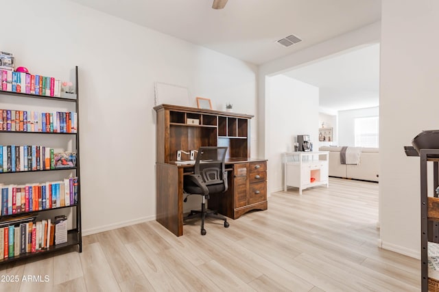 home office featuring light hardwood / wood-style flooring and ceiling fan