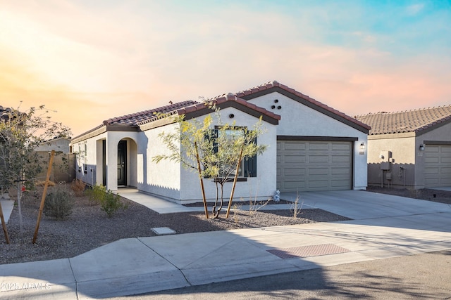 mediterranean / spanish home with a garage