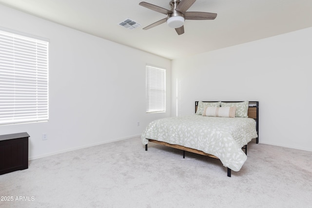 bedroom with ceiling fan and light colored carpet