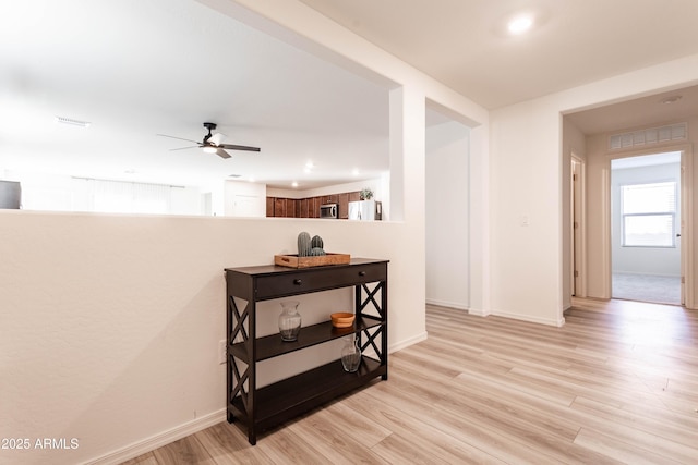 corridor with light hardwood / wood-style flooring