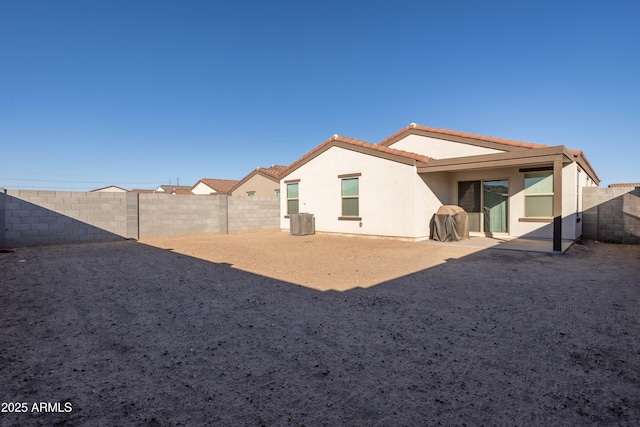 rear view of house featuring central air condition unit