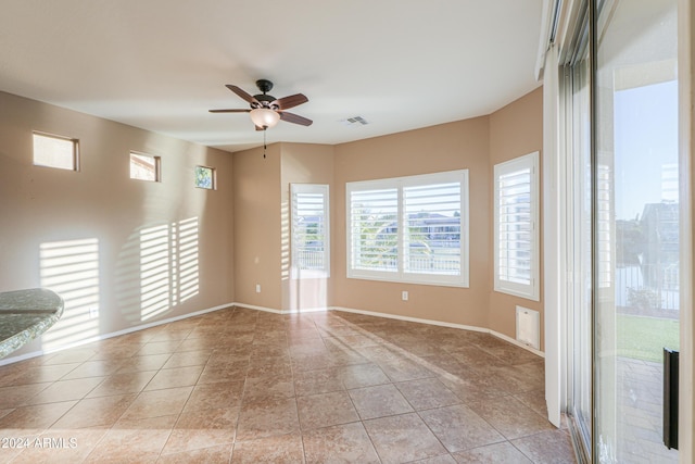 tiled empty room with ceiling fan