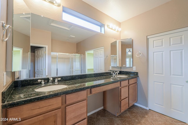 bathroom with tile patterned flooring, vanity, and a shower with shower door