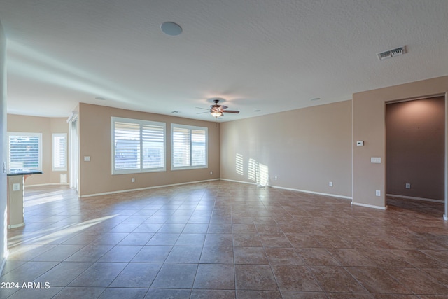 tiled empty room with ceiling fan