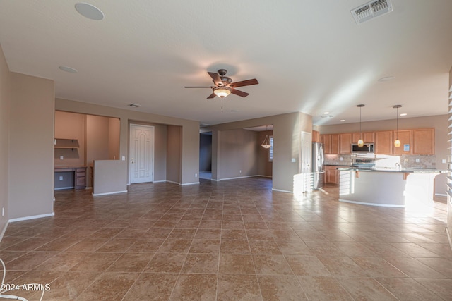 unfurnished living room with tile patterned floors and ceiling fan