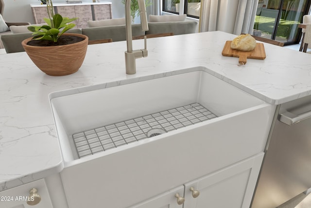 details featuring light stone countertops and sink