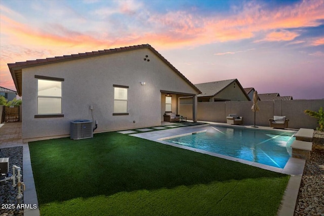 exterior space featuring a patio area, pool water feature, a yard, and central AC