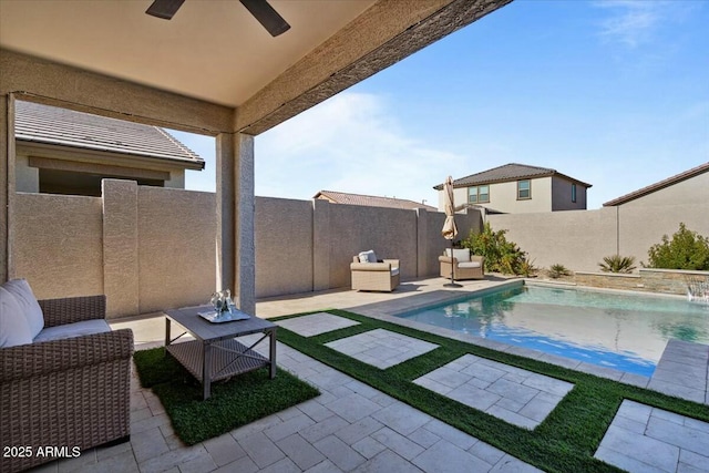 view of pool with ceiling fan, a patio, and pool water feature