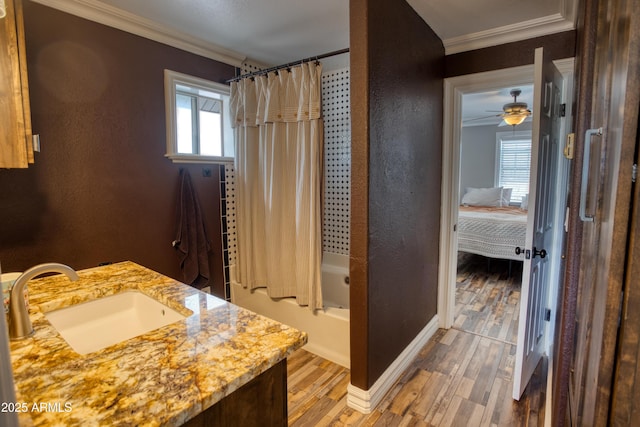 bathroom featuring vanity, hardwood / wood-style floors, ornamental molding, and shower / bath combo