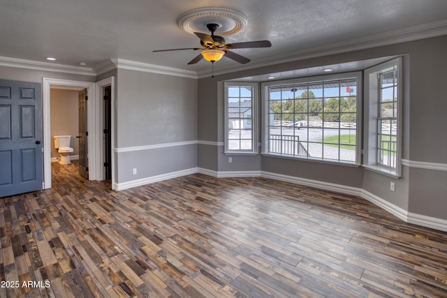 unfurnished room featuring dark hardwood / wood-style flooring, crown molding, and ceiling fan