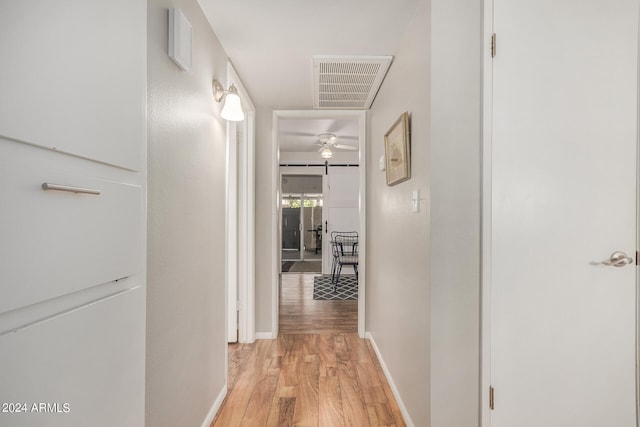 corridor with light hardwood / wood-style floors