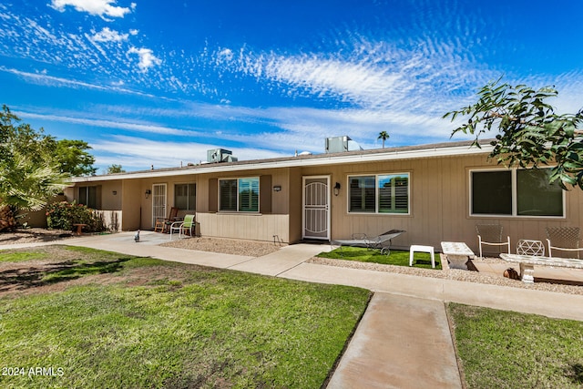 view of front of property with a front lawn and a patio area