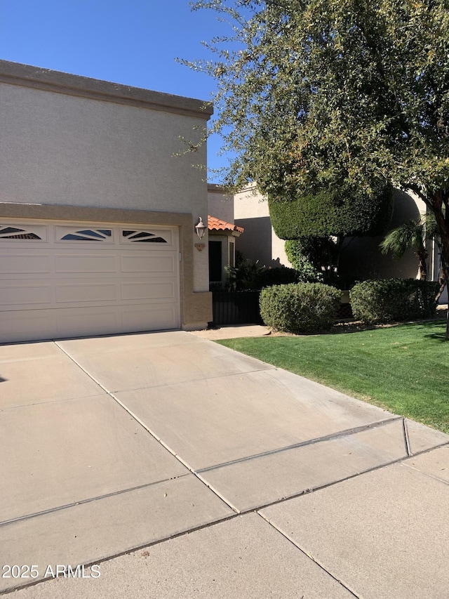 view of home's exterior with a garage and a yard