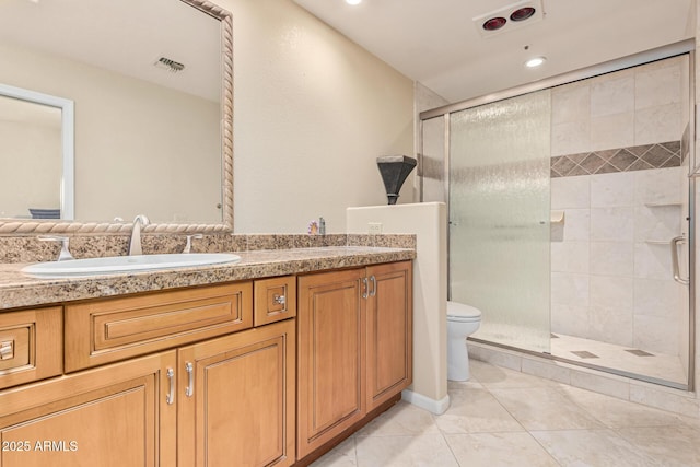 bathroom featuring vanity, toilet, a shower with shower door, and tile patterned flooring