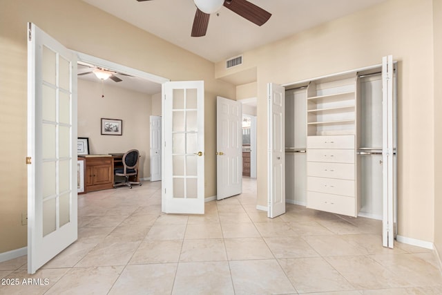 unfurnished bedroom with light tile patterned floors, french doors, and ceiling fan