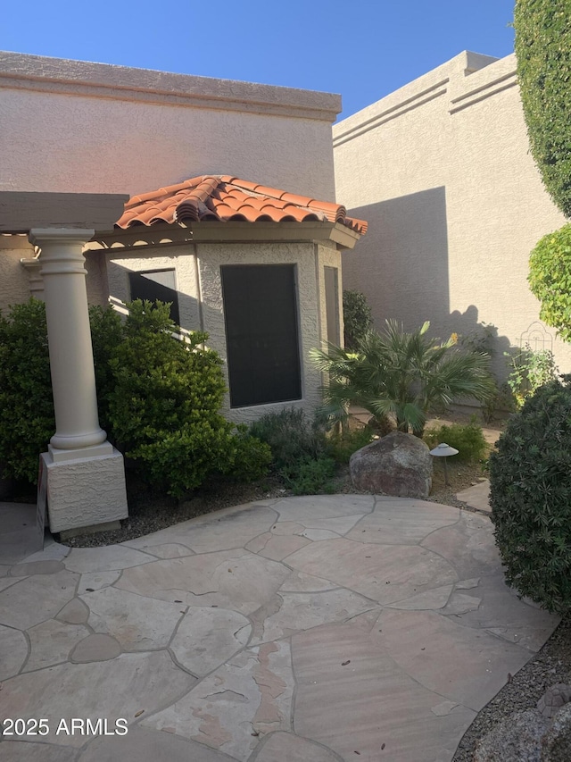 property entrance featuring a patio