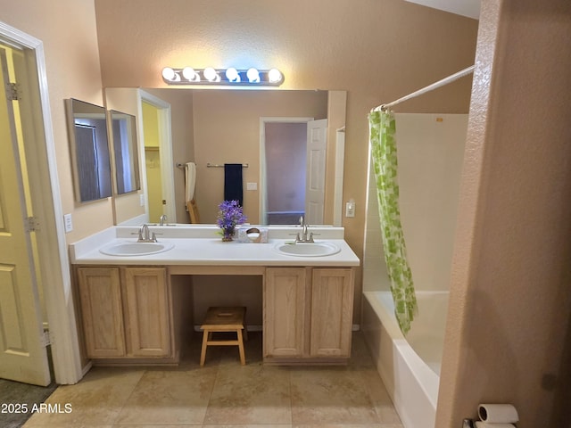 full bath with shower / tub combo with curtain, tile patterned floors, and double vanity