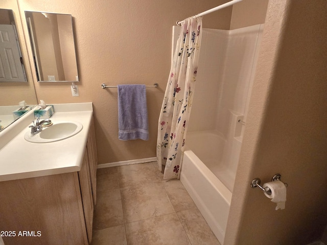 full bathroom with tile patterned flooring, vanity, shower / tub combo, and baseboards