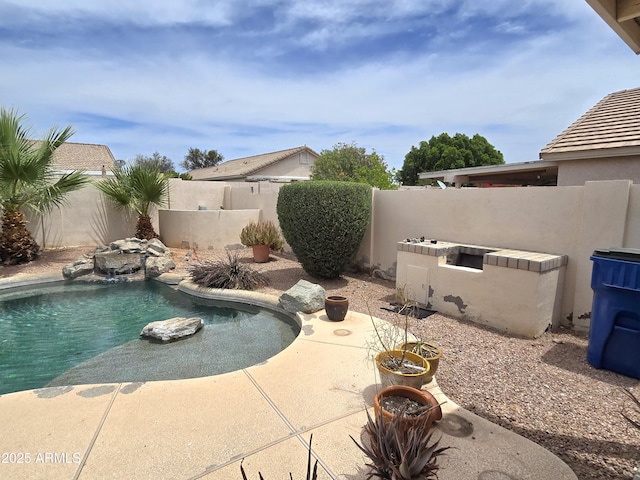 view of pool with a fenced backyard and a patio area