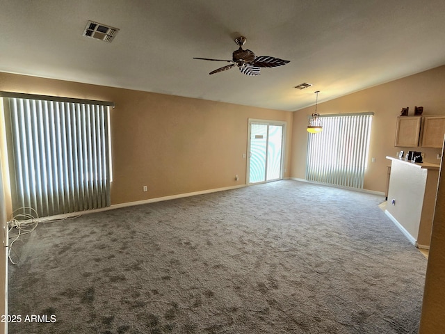 unfurnished living room featuring a ceiling fan, lofted ceiling, carpet flooring, and baseboards