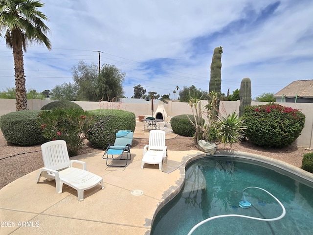 view of swimming pool featuring a patio and a fenced backyard