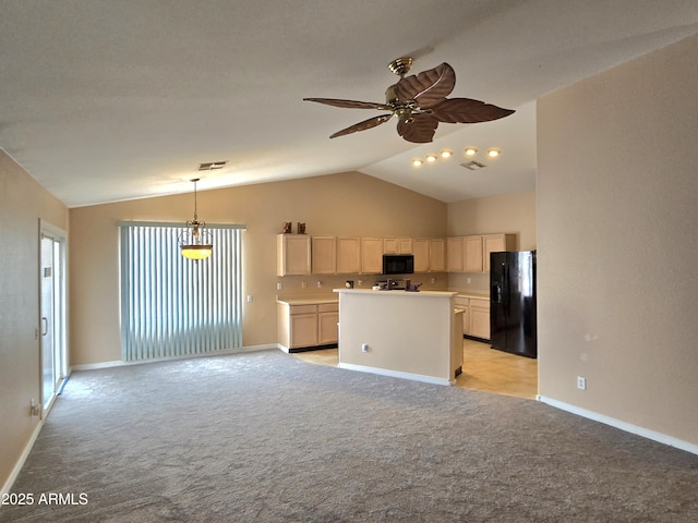 kitchen with black appliances, open floor plan, vaulted ceiling, light colored carpet, and a center island