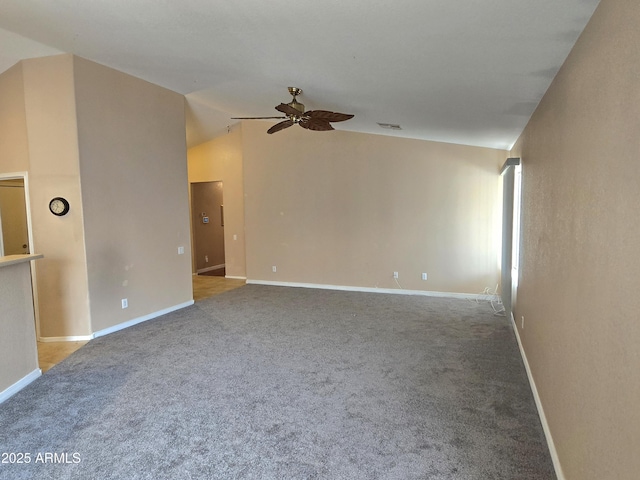 spare room featuring a ceiling fan, carpet flooring, lofted ceiling, and baseboards