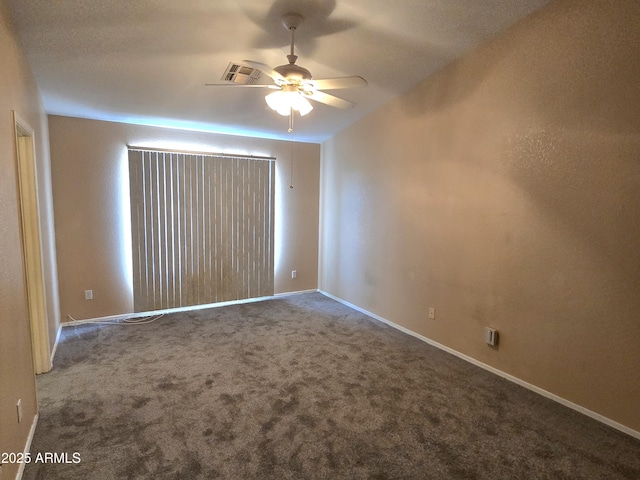 spare room with a ceiling fan, carpet floors, and baseboards