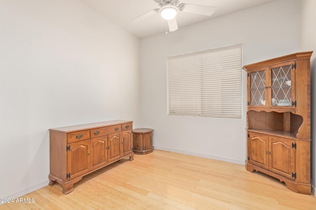 spare room with light wood-type flooring and ceiling fan