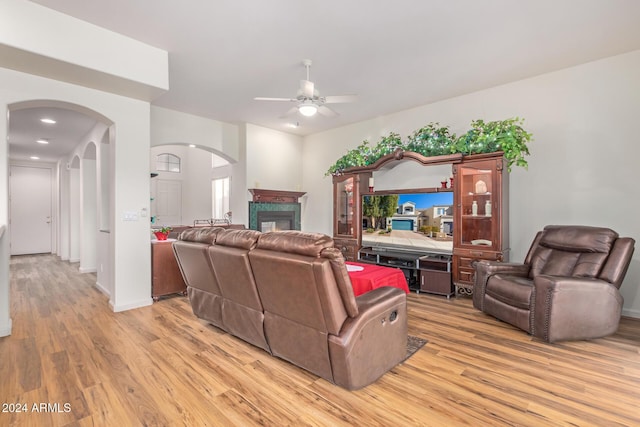 living room with ceiling fan and light hardwood / wood-style flooring