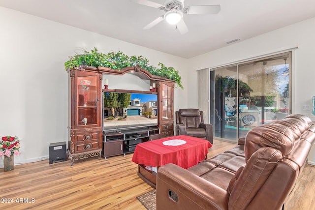 living room with ceiling fan and light hardwood / wood-style floors