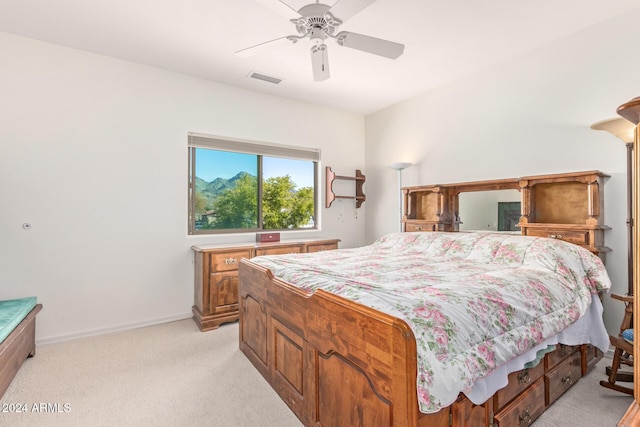 bedroom featuring ceiling fan and light carpet