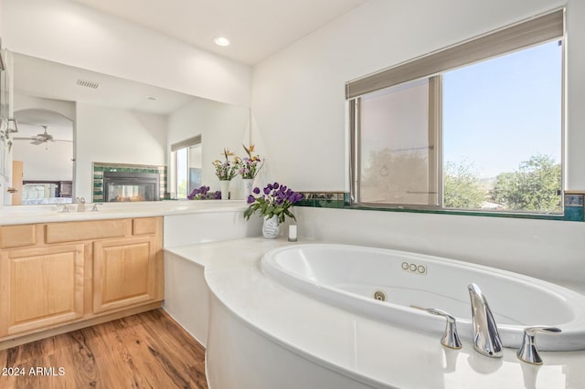 bathroom with hardwood / wood-style floors, vanity, a healthy amount of sunlight, and ceiling fan