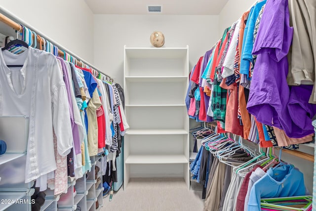 walk in closet featuring carpet flooring