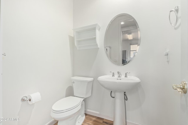 bathroom with wood-type flooring and toilet