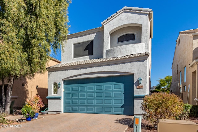 mediterranean / spanish-style home featuring a garage