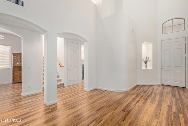 foyer with hardwood / wood-style flooring and a high ceiling