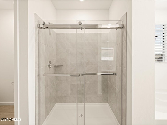 bathroom featuring an enclosed shower and wood-type flooring