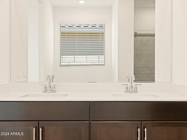 bathroom featuring a shower and vanity