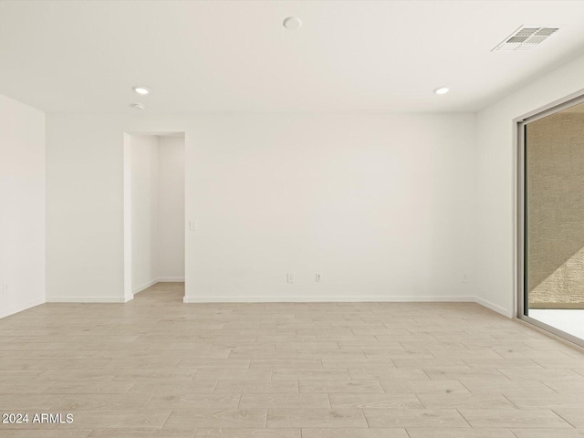 spare room with light wood-type flooring